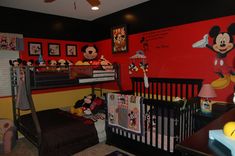 a mickey mouse themed nursery room with red walls