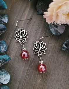 Gorgeous Tibetan silver lotus and red glass dangle earrings will turn heads every time you wear them!  Approximately 2 Inches Long Comes in Beautiful Satin Drawstring Gift Bag Perfect for Gift Giving! Spiritual Beaded Drop Earrings For Gift, Spiritual Beaded Drop Earrings, Adjustable Flower Earrings With Dangling Beads For Gifts, Red Hypoallergenic Round Bead Earrings, Red Spiritual Dangle Earrings, Handmade Earings, Beaded Boho Jewelry, Lotus Earrings, Glass Bead Earrings