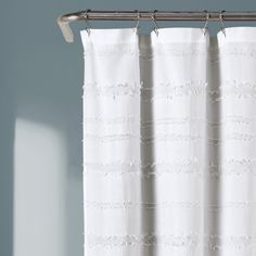 a white curtain hanging on a metal rod