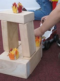 a child is playing with wooden toys on the floor