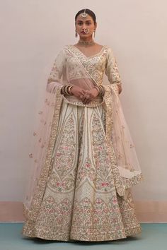 Ivory lehenga with zardozi embroidery using silken threads, dabka, cutdana and sequins. Comes with embroidered blouse and two embroidered dupattas.
Component: 4
Pattern: Embroidered
Type Of Work: Zardozi, silken threads, dabka, cutdana and sequins
Neckline: Plunged Neck
Sleeve Type: Short
Fabric: Raw Silk
Color: Ivory
Other Details: 
Broad neckline
Semi-sheer dupattas with embroidery
Occasion: Bride, Wedding - Aza Fashions Double Dupatta Bridal Lehenga, Double Dupatta, Ivory Lehenga, Latest Bridal Lehenga Designs, Bridal Lehenga Designs, Latest Bridal Lehenga, Raw Silk Lehenga, Floral Lehenga, Zardozi Embroidery