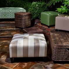 several wicker boxes sitting on top of a stone patio