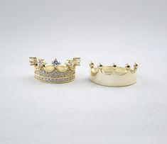 two gold rings with diamond crowns on them, one is white and the other is yellow