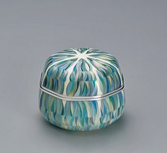 a blue and white box sitting on top of a gray table next to a silver object