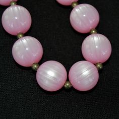 "This vintage necklace is lovely! Single stranded, it features pink moonglow plastic beads (possibly lucite), small metal bead spacers, and has a spring ring clasp. Beautiful! Measures 24.25\" from end to end. Condition : Good.. There's light wear on the beads." Vintage Pink Beaded Necklace With Round Beads, Pink Beads For Jewelry Making, Pink Polished Round Bead Necklaces, Pink Vintage Beaded Necklaces With Colorful Beads, Pink Round Beaded Necklaces With Spacer Beads, Pink Round Polished Bead Necklaces, Pink Polished Round Beads, Vintage Pink Beaded Necklace As A Gift, Pink Spacer Beads