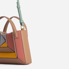 Mix of symmetry and fluid, clean lines, Mini Sera Tote is designed to carry your daily essentials, a large phone(like iPhone 11 Pro Max), mini wallet or cardholder, and lipstick, etc. Its exterior design is a surrealist dream, reminiscent of a maze-like structure protruding outwards, with sharp, clean lines, and a 3D façade. Opening the top handles reveals a suede drawstring top edge, securing your belongings on the go. Folding inwards like an accordion and then stretching outwards to store thos Modern Office Phone Bag Rectangular, Modern Rectangular Office Phone Bag, Modern Rectangular Phone Bag For Daily Use, Modern Phone Bag With Removable Pouch, Modern Square Phone Bag With Cell Phone Pocket, Modern Rectangular Phone Bag With Removable Pouch, Modern Square Phone Bag For Everyday Use, Modern Office Bags With Card Slots, Modern Office Bag With Card Slots