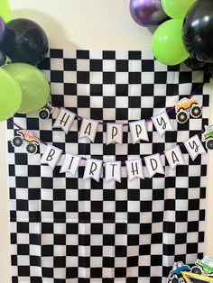 a black and white checkered birthday backdrop with balloons