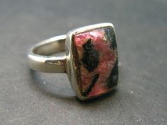 This is a very nice large Tugtupite ring set in sterling silver and gold plated sterling silver from Greenland with a nice deep pink color and good fluorescence.  Location: Greenland Size: Size 7 Weigh: 3.72 Grams Deep Pink, Gold Plated Sterling Silver, Ring Set, Sterling Silver Ring, Ring Sets, Pink Color, Silver Ring, Sterling Silver Rings, Jewelry Rings