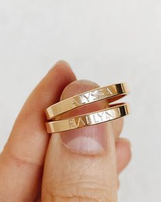 two gold rings with roman numerals engraved on them in the palm of someone's hand