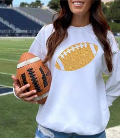 Game Day sparkly shirts to support your favorite team! Size up for an oversized look. Multiple color selections  Ideal for any situation, a unisex heavy blend crewneck sweatshirt is pure comfort. These garments are made from polyester and cotton. This combination helps designs come out looking fresh and beautiful. The collar is ribbed knit, so it retains its shape even after washing. There are no itchy side seams on these sweaters.  .: 50% cotton, 50% polyester .: Medium-heavy fabric (8.0 oz/yd² (271.25 g/m .: Loose fit .: Sewn-in label .: Runs true to size Mom Halloween Costumes, Custom Team Shirts, Black And Gold Shirt, Friday Night Football, Ncaa Football Teams, Mom Costumes, Football Crewneck, Gold Football, Football 49ers