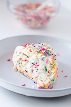 a piece of cake on a plate with sprinkles