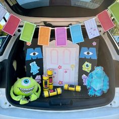 the trunk of a car decorated with monsters and crayons