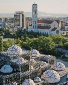 an aerial view of several domes in front of a city