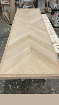 an unfinished wooden table in the process of being made with wood veneers and plywood