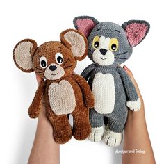 two stuffed animals are being held in the palm of someone's hand, one is brown and one is gray