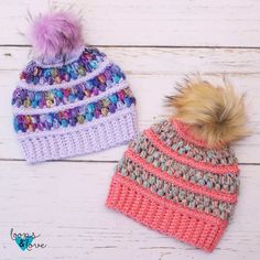 two crocheted hats with pom - poms on them