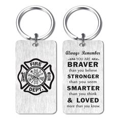 two metal key chains with fire department sayings on them