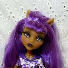 a doll with purple hair and horns on it's head, wearing a dress