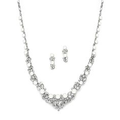 a necklace and earring set with pearls on the bottom, along with a pair of earrings