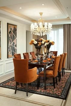 a dining room table with chairs and a chandelier