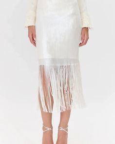 Sequin, midi skirt rendered in a clean white. The skirt is most noticeable for it's sequin, fringe hem. It's a classic design that's made to stand out. Midi Skirt Fringe Sequin Lined Length: 33 1/2" Waist 13 3/4" Self: 95% Polyester 5% Spandex Lining: 100% Polyester Model is wearing a size S Return Policy ALL regular price items may be returned for a store credit. Items must be received by us within 14 days. Item must still have tags on and be unworn. ***JEWELRY, handbags, lingerie, scarves, swi Sequin Fringe Skirt, Sequin Midi Skirt, Fringe Skirt, Stay Classy, Sweater Coats, Order Online, Denim Dress, Classic Design, Sweater Top