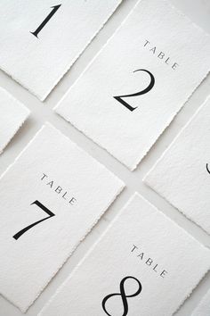 the table numbers are laid out on top of each other in black and white paper