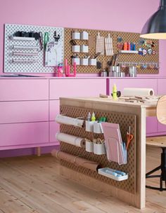 a pink kitchen with lots of craft supplies