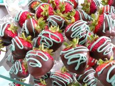 chocolate covered strawberries are sitting on display