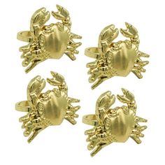 four gold crab cufflinks on a white background