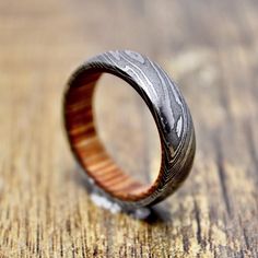 a wooden and metal ring sitting on top of a table