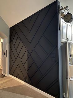 a kitchen with a refrigerator and clock on the wall