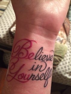 a wrist tattoo with the words believe in yourself on it