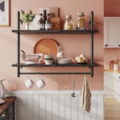 a kitchen with pink walls and shelves filled with utensils, plates, bowls and cups