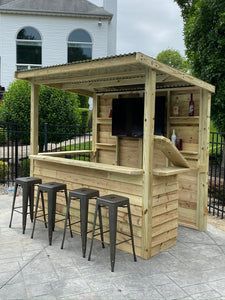 an outdoor bar made out of pallets with stools and barstools around it