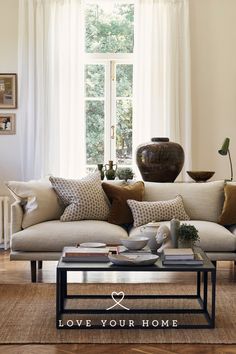 a living room filled with furniture next to a window