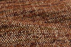 close up view of an area rug with brown and white patterns