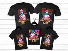 the matching family shirts are black with pink and blue unicorns, one is wearing a crown