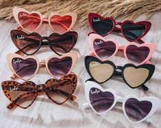 six pairs of heart shaped sunglasses with the word love written on them, all in different colors