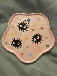 a pink plate with black and white designs on it