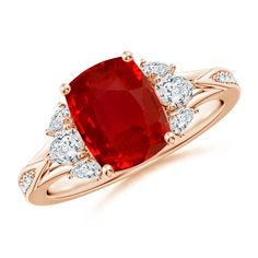 a red stone and diamond ring on a white background