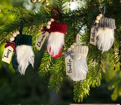 three christmas ornaments hanging from a tree with name tags on them, one for santa and the other for dad