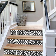 the stairs are decorated with black and white stencils for decorative wallpapers