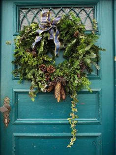 a green door with a wreath on it