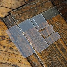 an old wooden floor with some glass on it