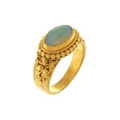 This charming 24k yellow gold ring features a 9 x 6mm oval opal, approximately 0.75ct in size, bezel set in East-West direction. This opal is free of fractures and has a high color intensity of green and blue with lots of flashfire. Polish is good to fair. The sides of the ring are embellished with gold beading and a raised detailed floral leaf motif that runs along the sides of the shank.  The ring measures 6.7mm at the top of the shank and tapers to 3.47mm at the base. The opal rises 4.4mm abo Luxury Opal Ring With Oval Cabochon, Luxury Classic Opal Ring Oval Cabochon, Oval Opal Ring, Leaf Motif, Green Opal, Opal Ring, Yellow Gold Ring, East West, Oval Cabochon