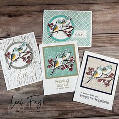 four cards with birds on them sitting next to each other in front of a wooden background