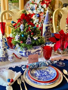 a christmas table setting with blue and white china