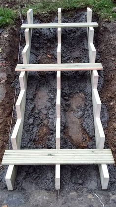 a wooden bench sitting on top of a pile of dirt