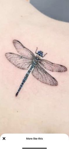 a small dragonfly tattoo on the back of a woman's left ribcage