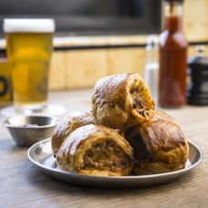 several pastries on a plate with beer in the background